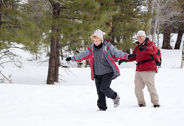 senior couple walking in the snow