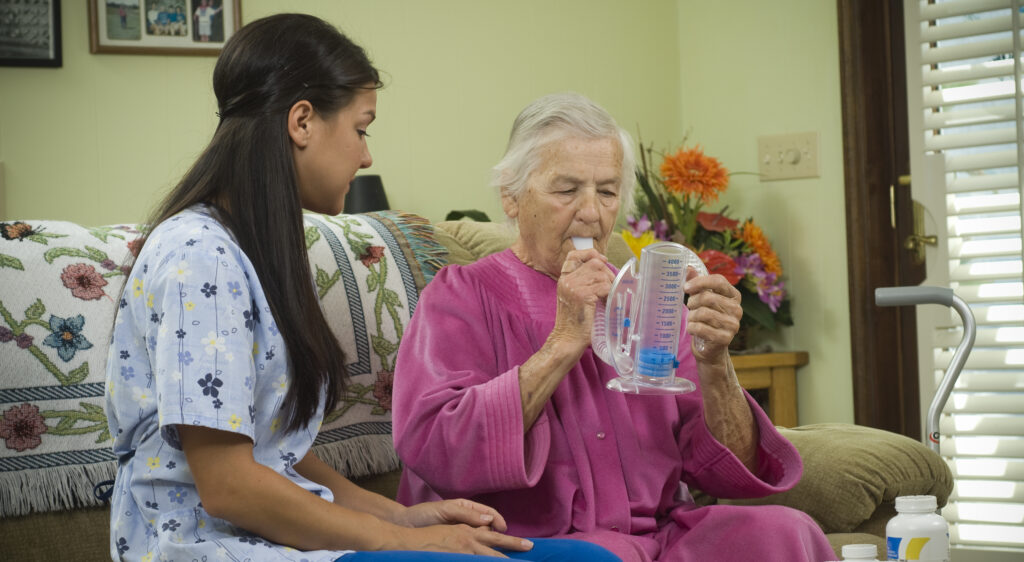 Nurse with senior citizen testing lung strength