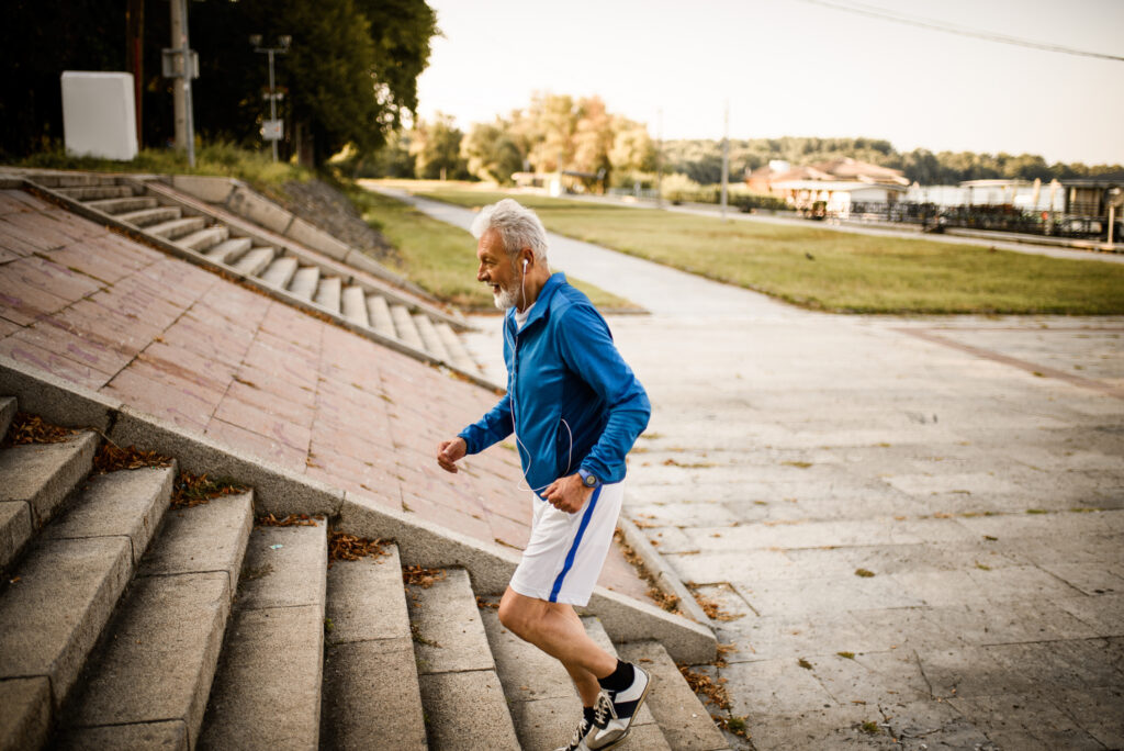 Side view of a senior man running up the stairs