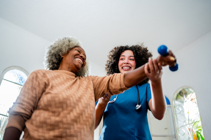 Healthcare Worker helping patient to exercising on a nursing Home